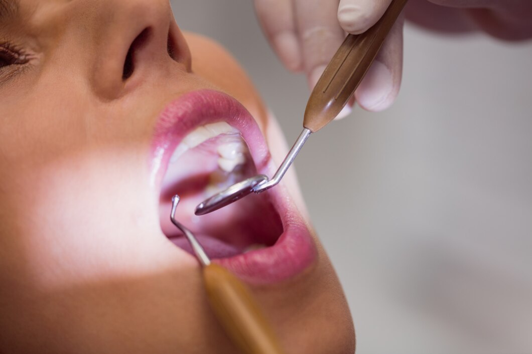 dentist-examining-female-patient-teeth_107420-65306.jpg