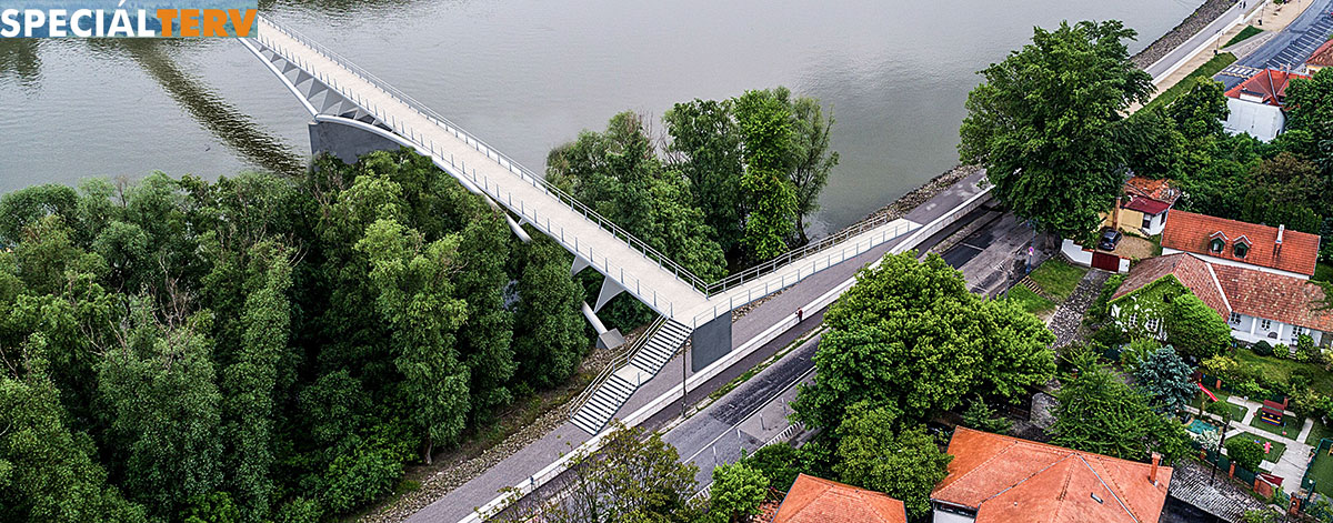 Az EuroVelo 6 nemzetközi kerékpárút részeként tervezett gyalogos és kerékpáros híd Szentendre belvárosánál, a Pásztor révnél, ill. a Rév utcánál a Speciálterv Építőmérnöki Kft. látványtervén.<br /><br />Fotó: Speciálterv / szentendre.hu