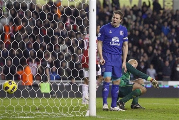 20110101_Everton's Phil Jagielka stands dejected after scoring an own goal past goalkeeper Tim Howard, right, during the English Premier League soccer match against Stoke City at the Britannia Stadium.jpg