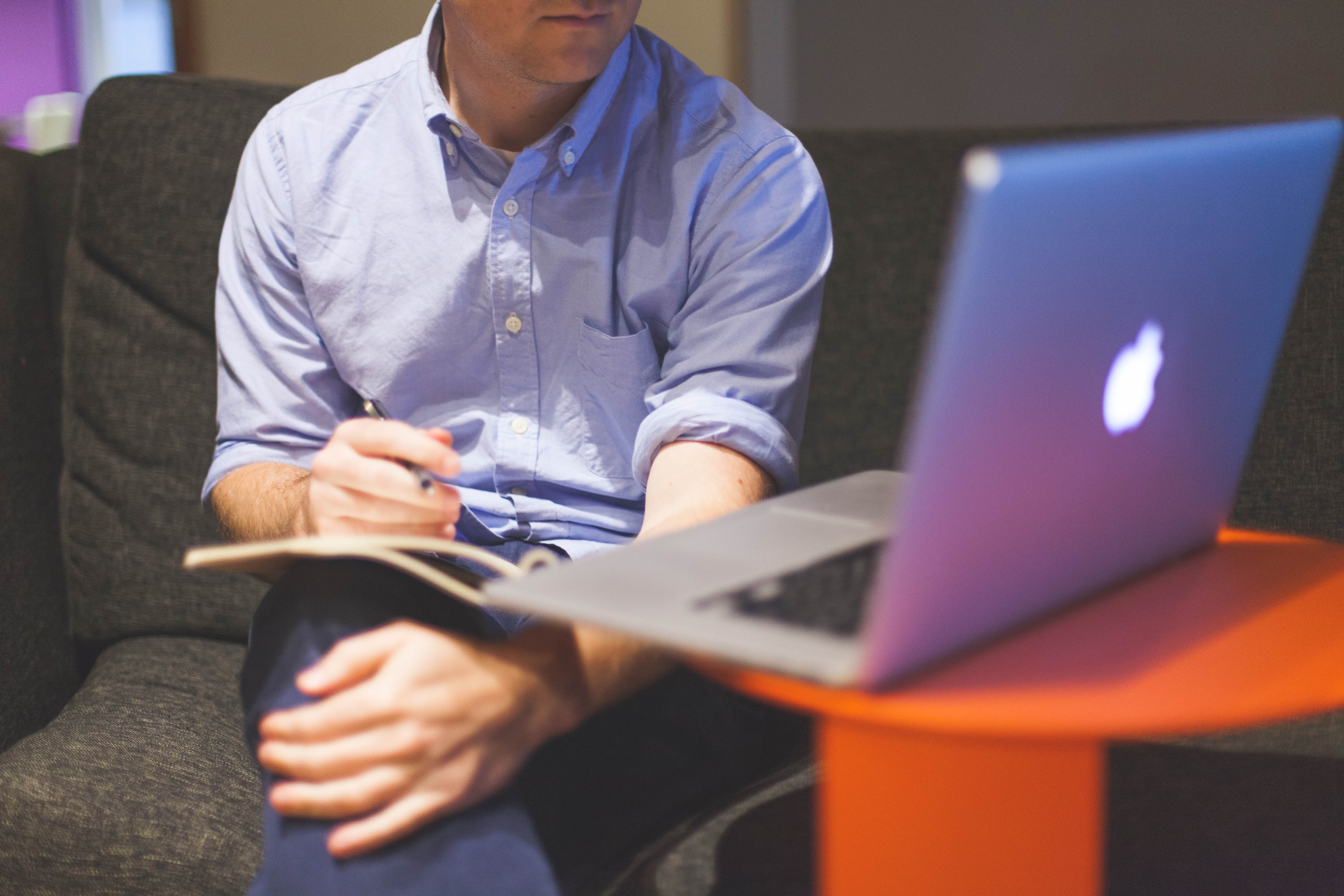 man-notes-macbook-computer.jpg