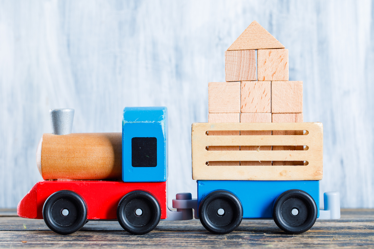 kindergarten-concept-with-wooden-blocks-kid-toys-wooden-grungy-background-side-view.jpeg
