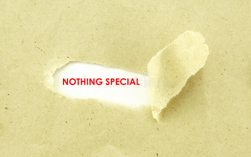nothing-special-text-appearing-behind-torn-light-brown-envelope-77924166.jpg