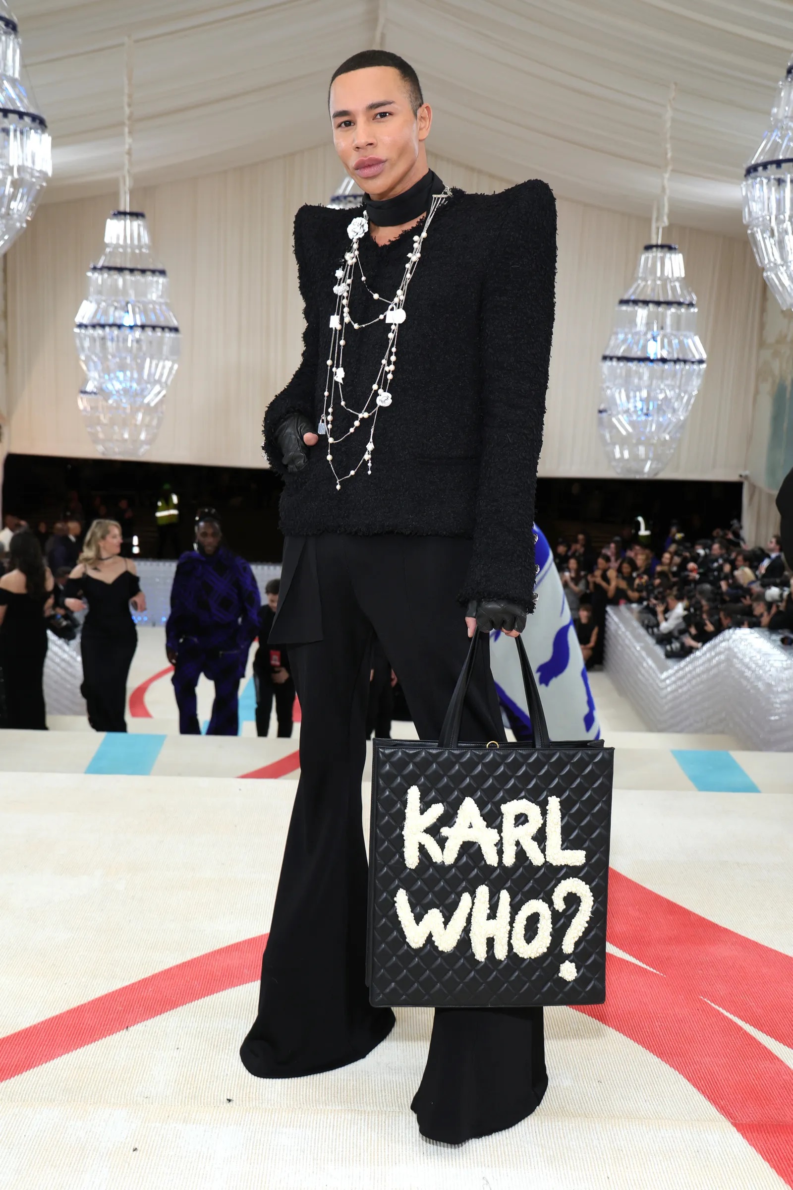 balmain_s_creative_director_olivier_rousteing_wore_a_handbag_with_the_words_karl_who_sprayed_painted.jpg
