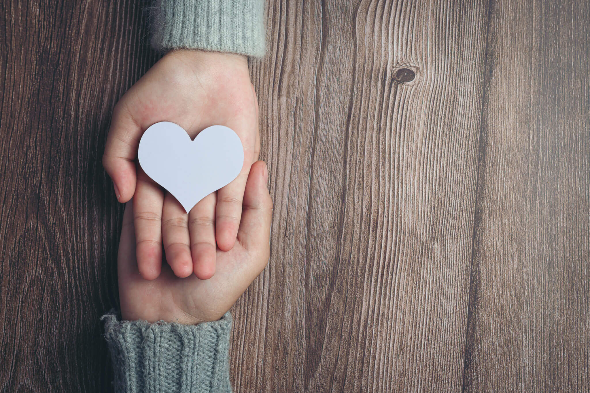 closeup-on-two-young-lovers-holding-hands-at-a-table-2048x1365.jpg