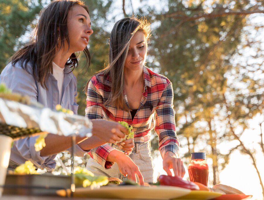 women-arranging-delicious-food-table-friends-join_23-2148733710.jpg