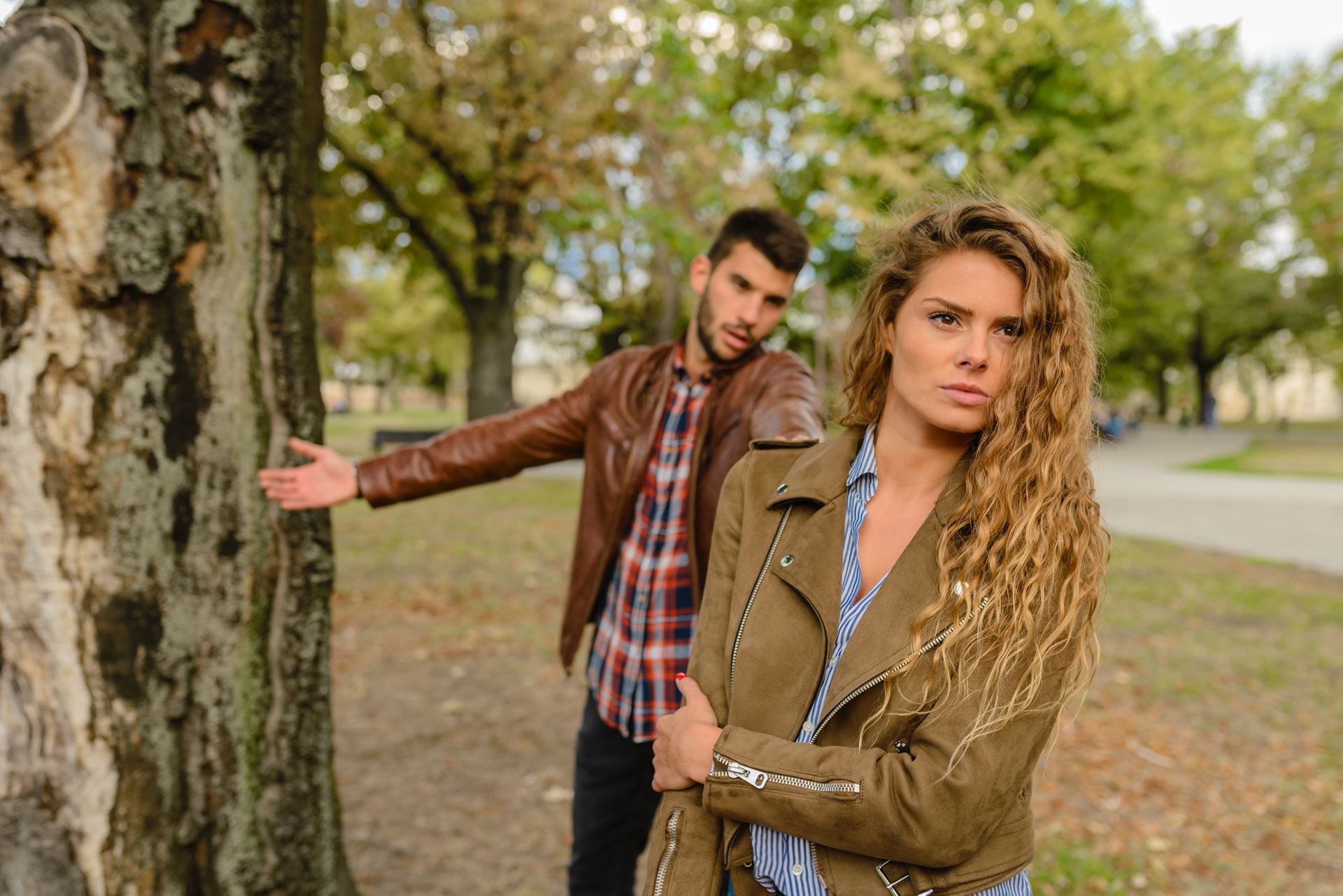 woman-and-man-wearing-brown-jackets-standing-near-tree-984954.jpg