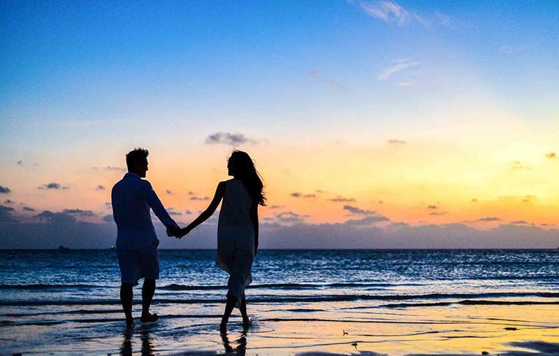 couple-holding-hands-on-a-beach.jpg