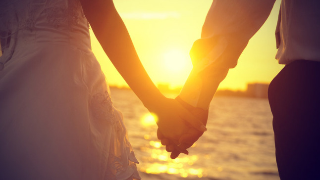 man-and-woman-holding-hands-in-sunset.jpg