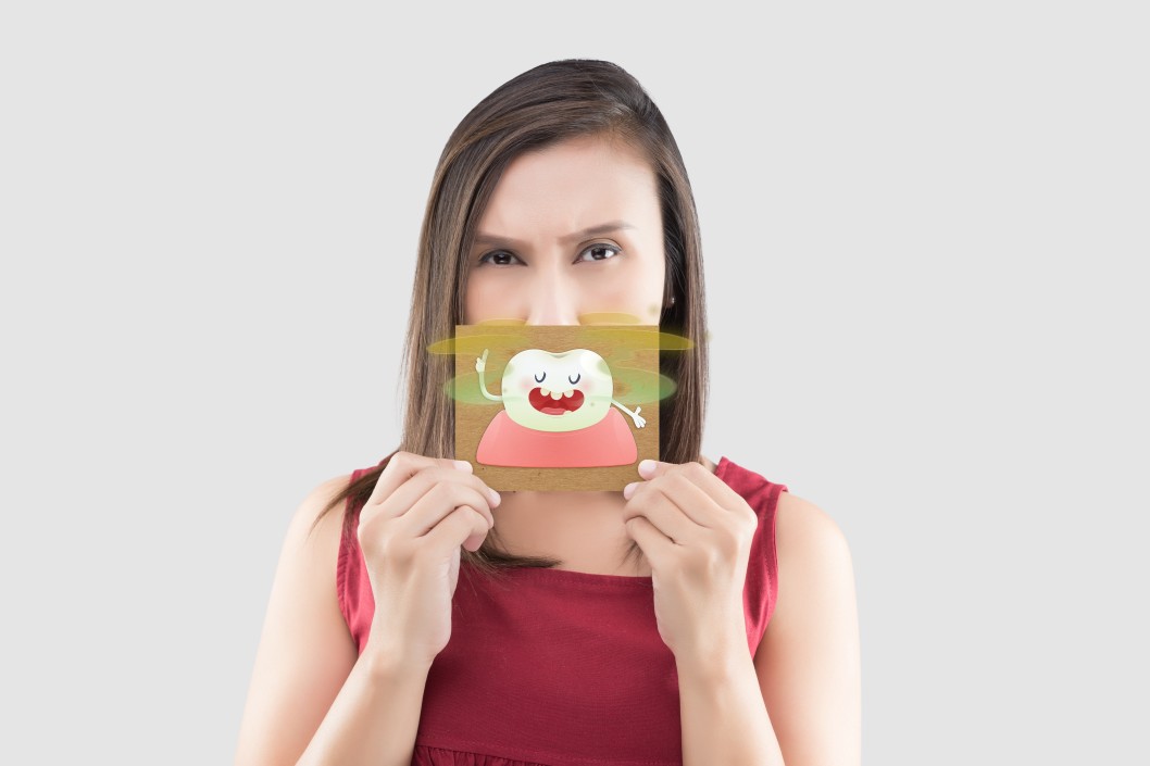 asian-woman-in-the-red-shirt-holding-a-brown-paper-with-the-yellow-teeth-cartoon-picture-of-his-mouth_t20_4bglgx.jpg