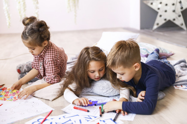 three-focused-children-are-playing-floor-drawing-coloring-books_8353-10845.jpg