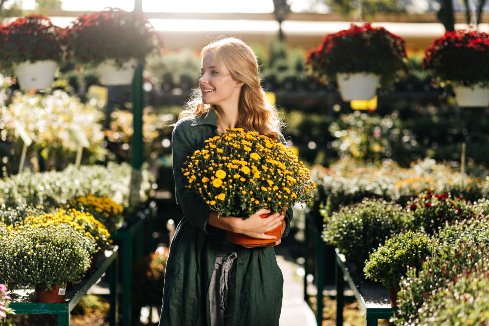 young-woman-with-beautiful-blond-hair-gentle-smile-dressed-green-robe-with-belt-is-working-greenhouse.jpg