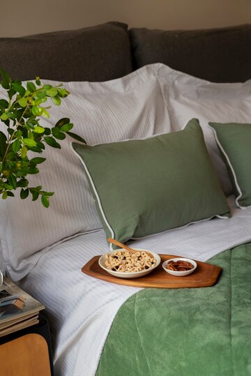 high-angle-cozy-bed-arrangement-with-breakfast_23-2150326150.jpg