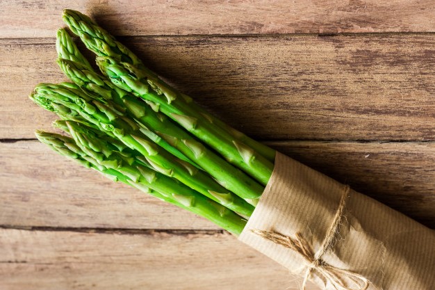bunch-green-fresh-asparagus-tied-with-twine-lying-aged-plank-wood-table_76014-54.jpg