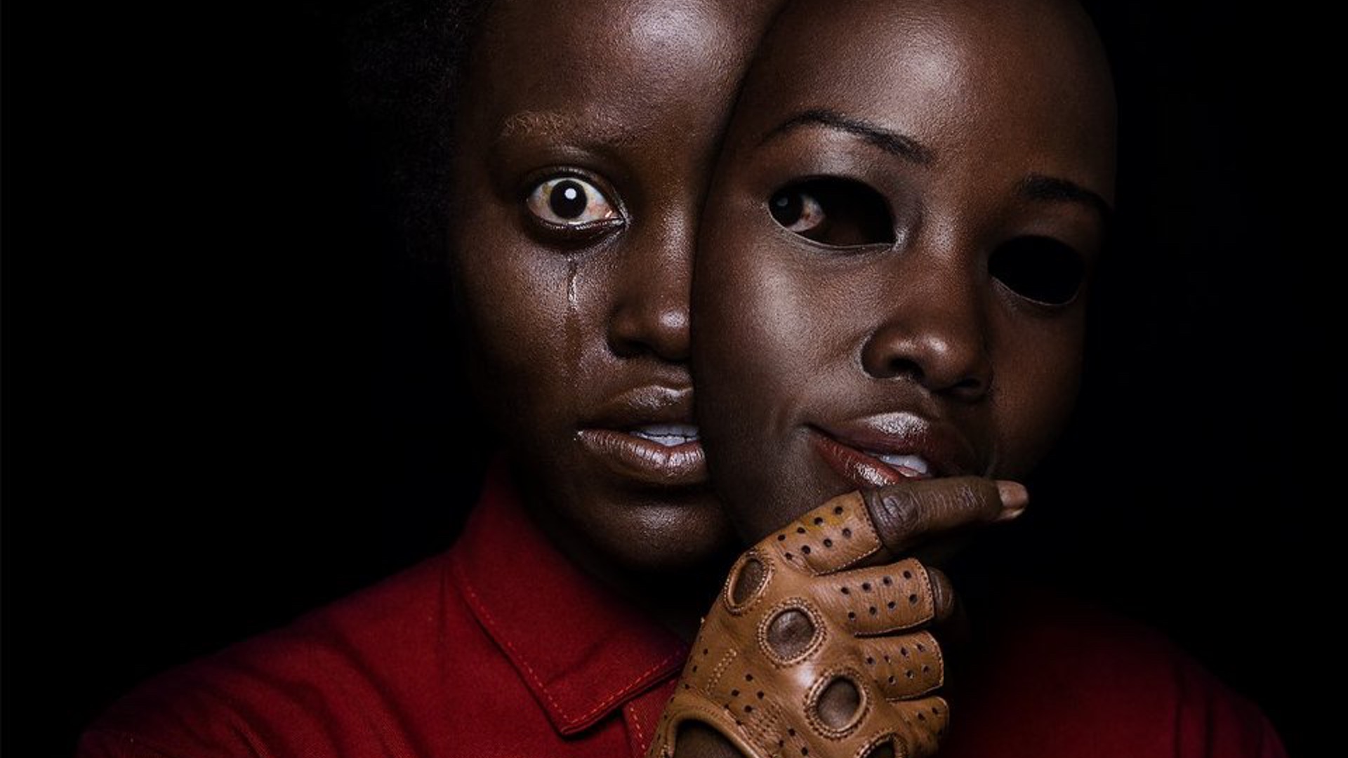 unsettling-new-poster-for-jordan-peeles-us-features-lupita-nyongo-holding-a-mask-of-her-own-face-social.jpg