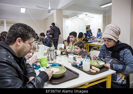 epa04578255-people-eat-in-a-caritas-soup-kitchen-in-athens-greece-ef36tw.jpg