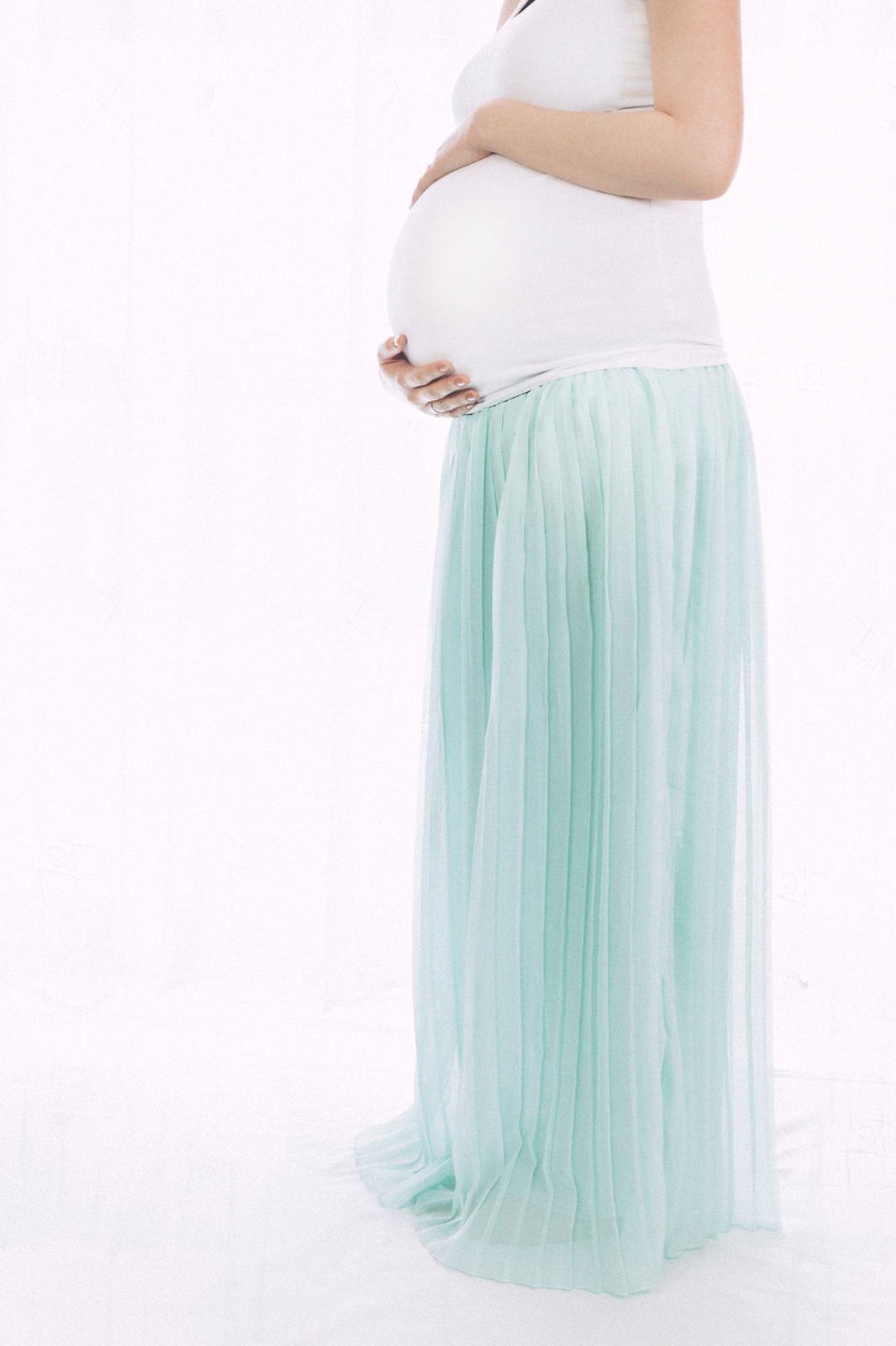 canva-pregnant-woman-standing-in-front-of-white-wall-madgx_gp5bw.jpg