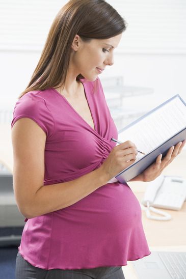 photodune-331115-pregnant-woman-at-work-writing-in-binder-xs.jpg