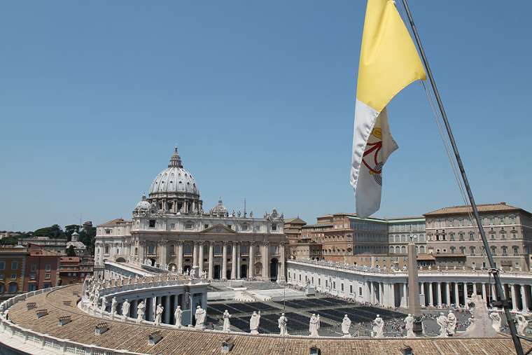 a_view_of_st_peters_basilica_2_and_vatican_city_flag_from_the_roof_of_a_nearby_building_on_june_5_2015_credit_bohumil_petrik_cna_6_5_15.jpg