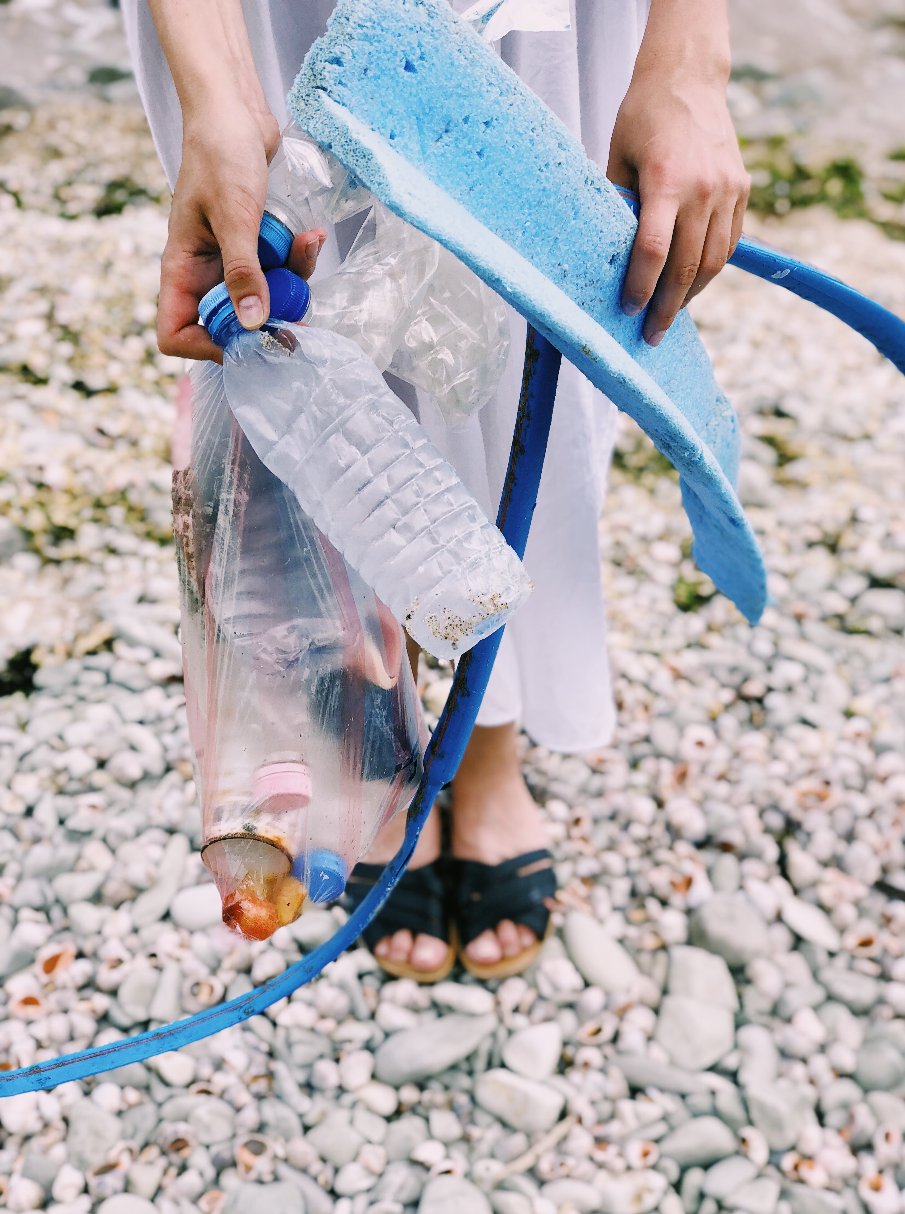 person-holding-plastic-bottles-and-hose-1201589.jpg