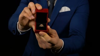 videoblocks-hands-of-elegant-man-holding-and-presenting-jewelry-box-with-ring-inside_sbwojidrrx_thumbnail-small08.jpg