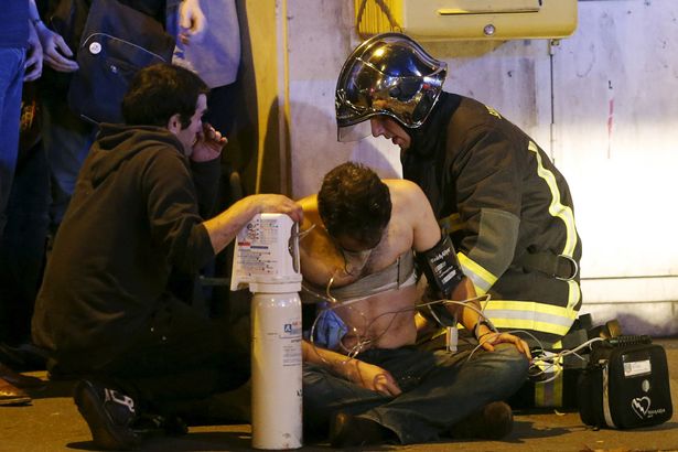 french-fire-brigade-members-aid-an-injured-individual-near-the-bataclan-concert-hall.jpg