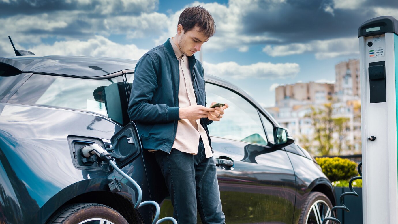 man-charging-his-electric-car-charge-station-using-smartphone_1268-17738.jpg