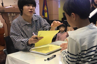 INFINITE's Sung Jong holds a mini fan sign event for the Sunday school kids at his church