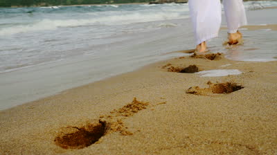 stock-footage-footsteps-made-in-sand-by-man-in-white-religious-concept-background-hd.jpg