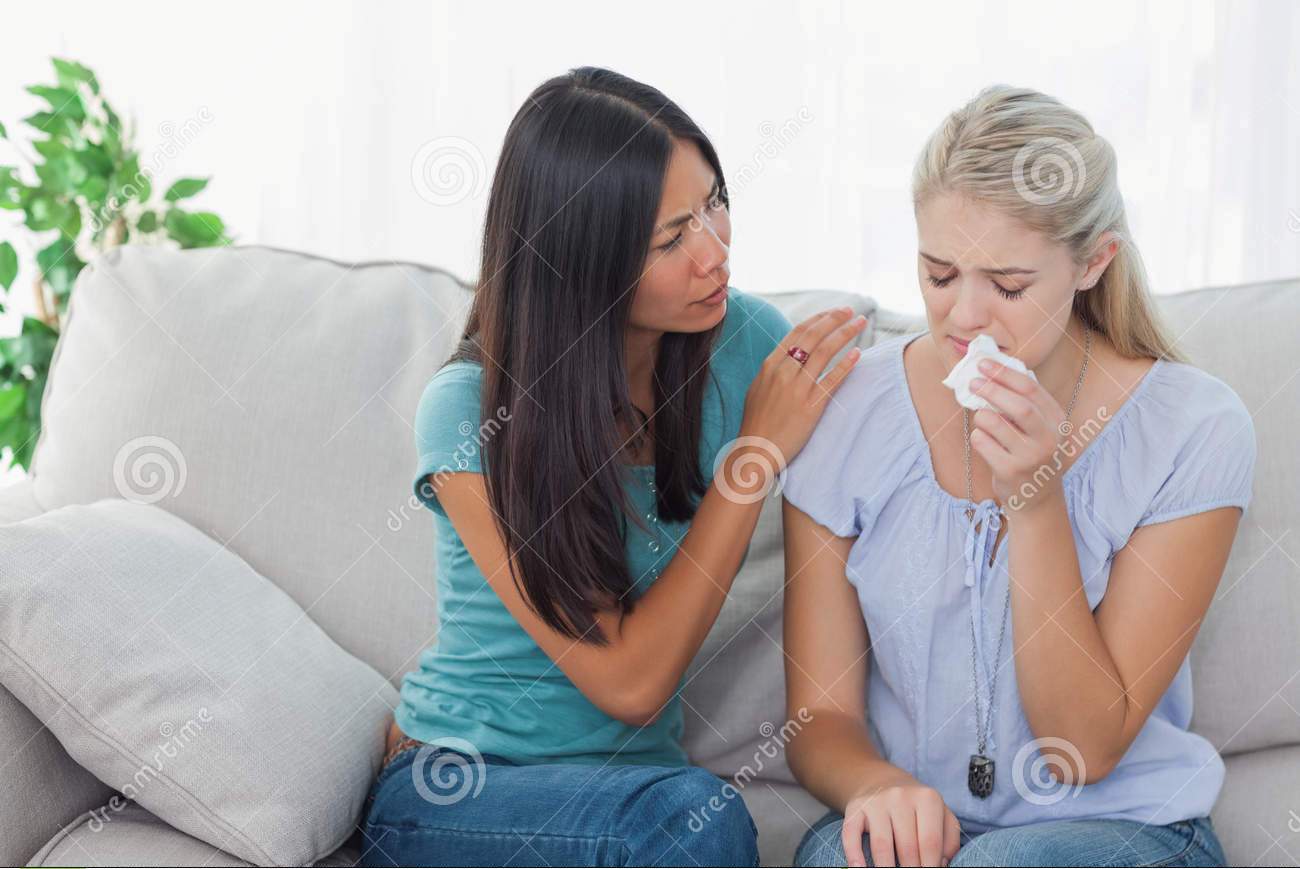 concerned-woman-comforting-her-crying-friend-women-home-couch-33051719.jpg