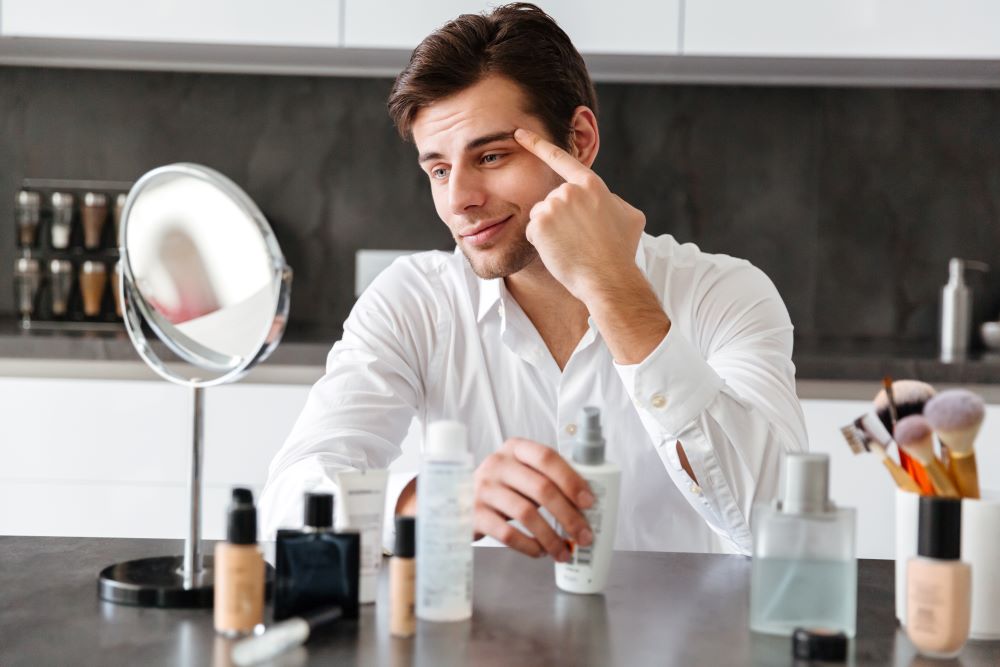 handsome-young-man-applying-makeup-beauty-products.jpg