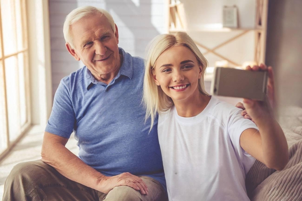 63889130-beautiful-young-girl-volunteer-and-handsome-old-man-are-doing-selfie-using-a-smart-phone-and-smiling-transformed.jpeg