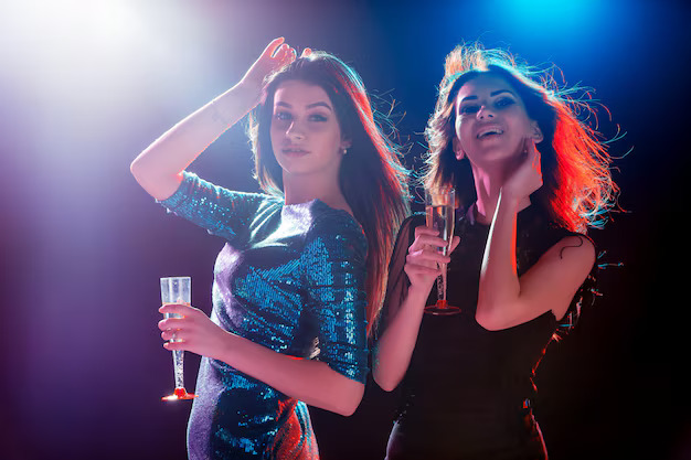two-beautiful-girls-dancing-party-drinking-champagne_155003-7878.jpg