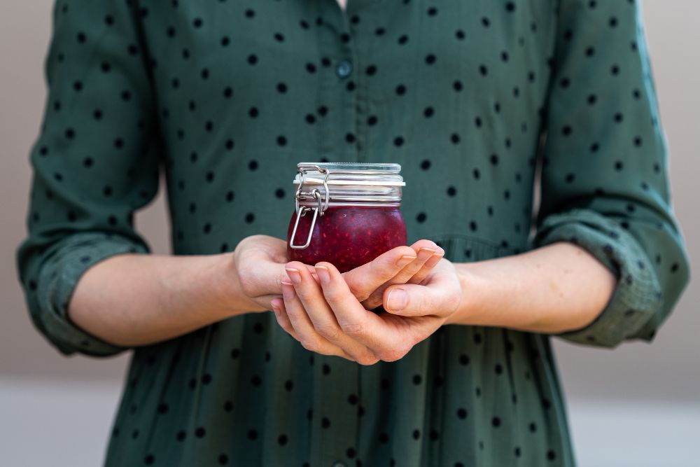 female-hands-holding-homemade-vegan-raw-raspberry-jam-glass-jar.jpg