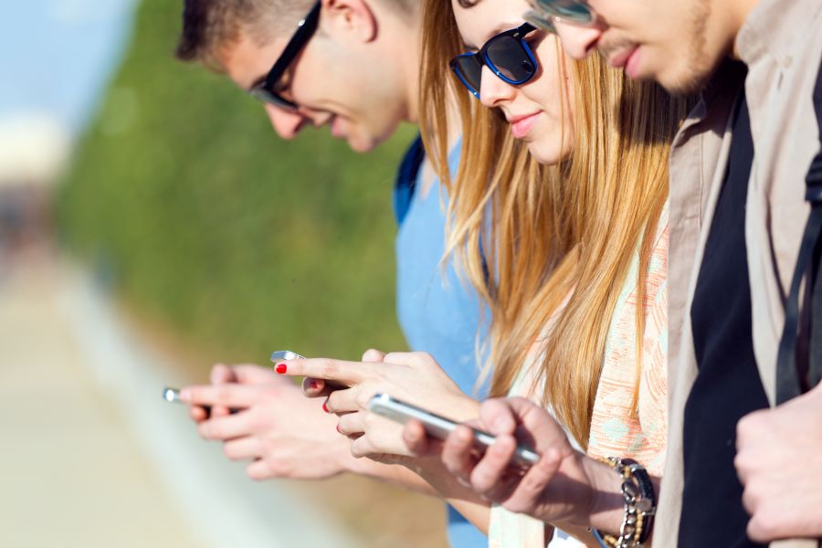 group-students-having-fun-with-smartphones-after-class.jpg