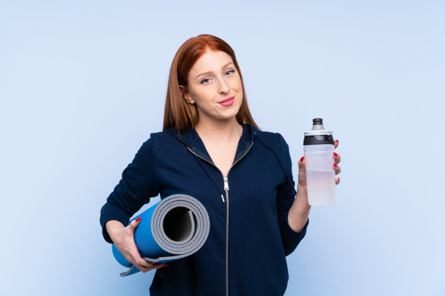 young-redhead-sport-woman-with-sports-water-bottle-with-mat_1368-66623.jpg
