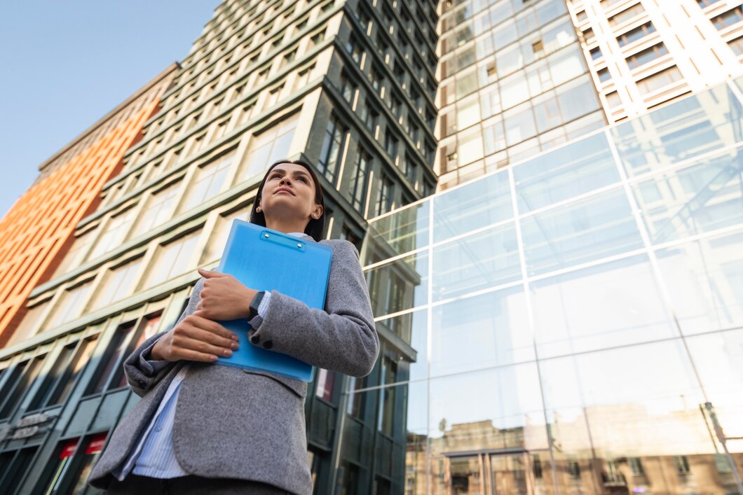 low-angle-businesswoman-holding-clipboard-city_23-2148767025.jpg