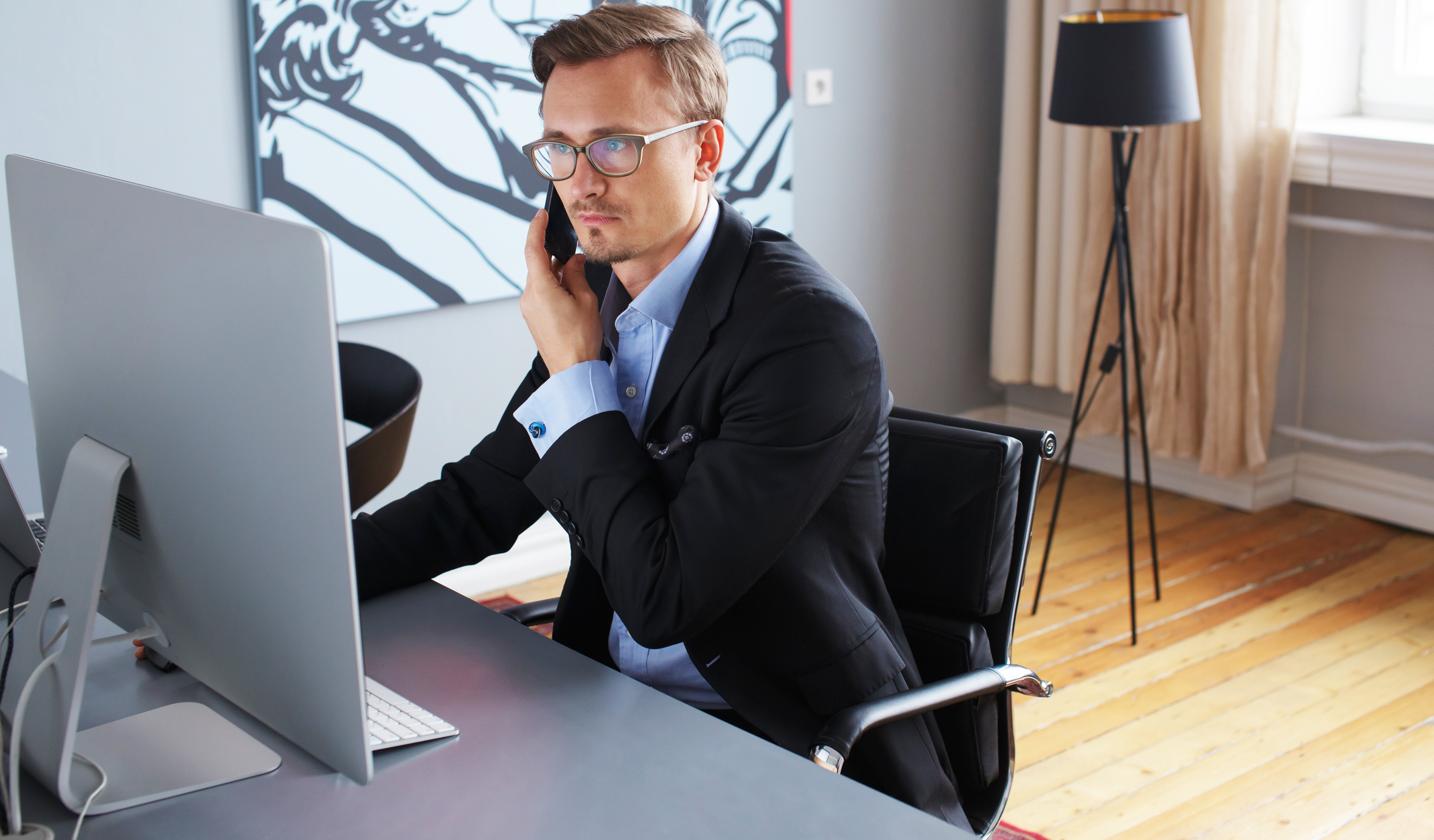 young-business-man-speaking-phone-office.jpg