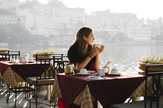 western-woman-having-teatime-cafe-udaipur_53876-65360.jpg