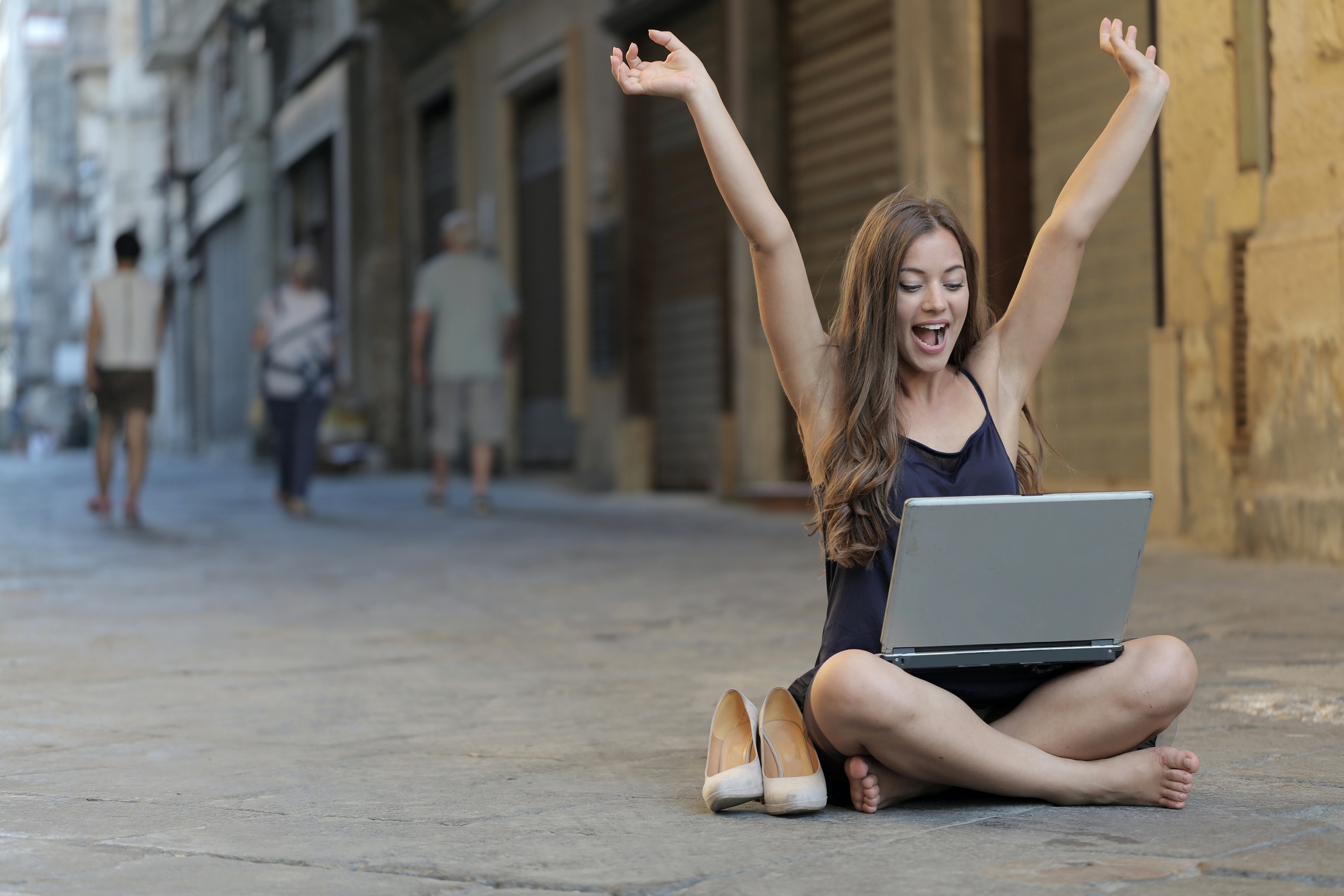 andrea_piacquadio_pexels_woman-raising-her-hands-up-while-sitting-on-floor-with.jpg