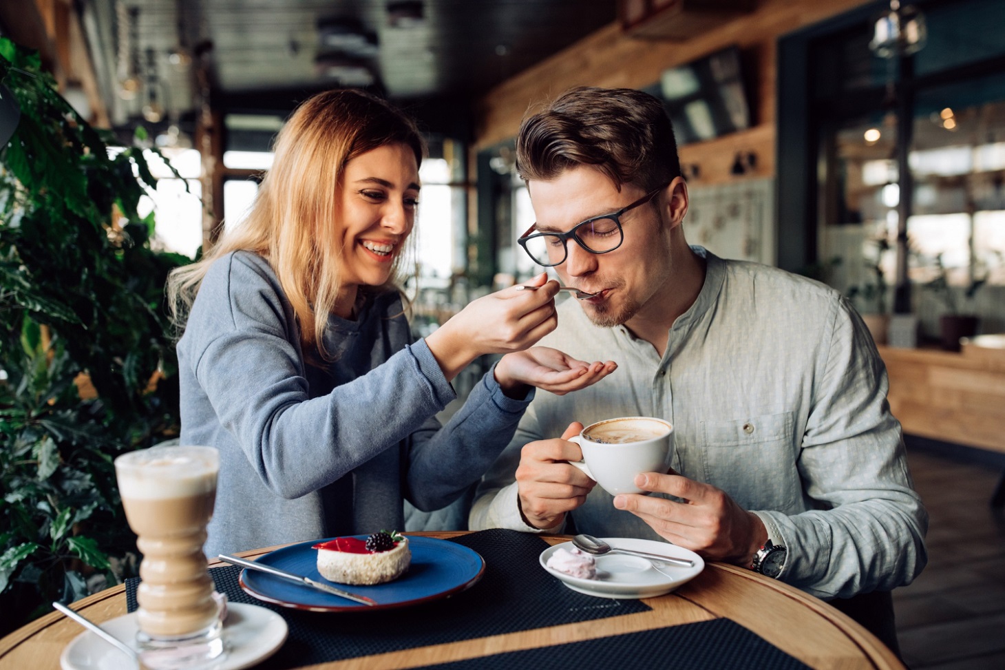 beautiful-smiling-girl-feeds-her-handsome-boyfriend-eating-tasty-cake-drinking-coffee_freepic_diller_freepik.jpg