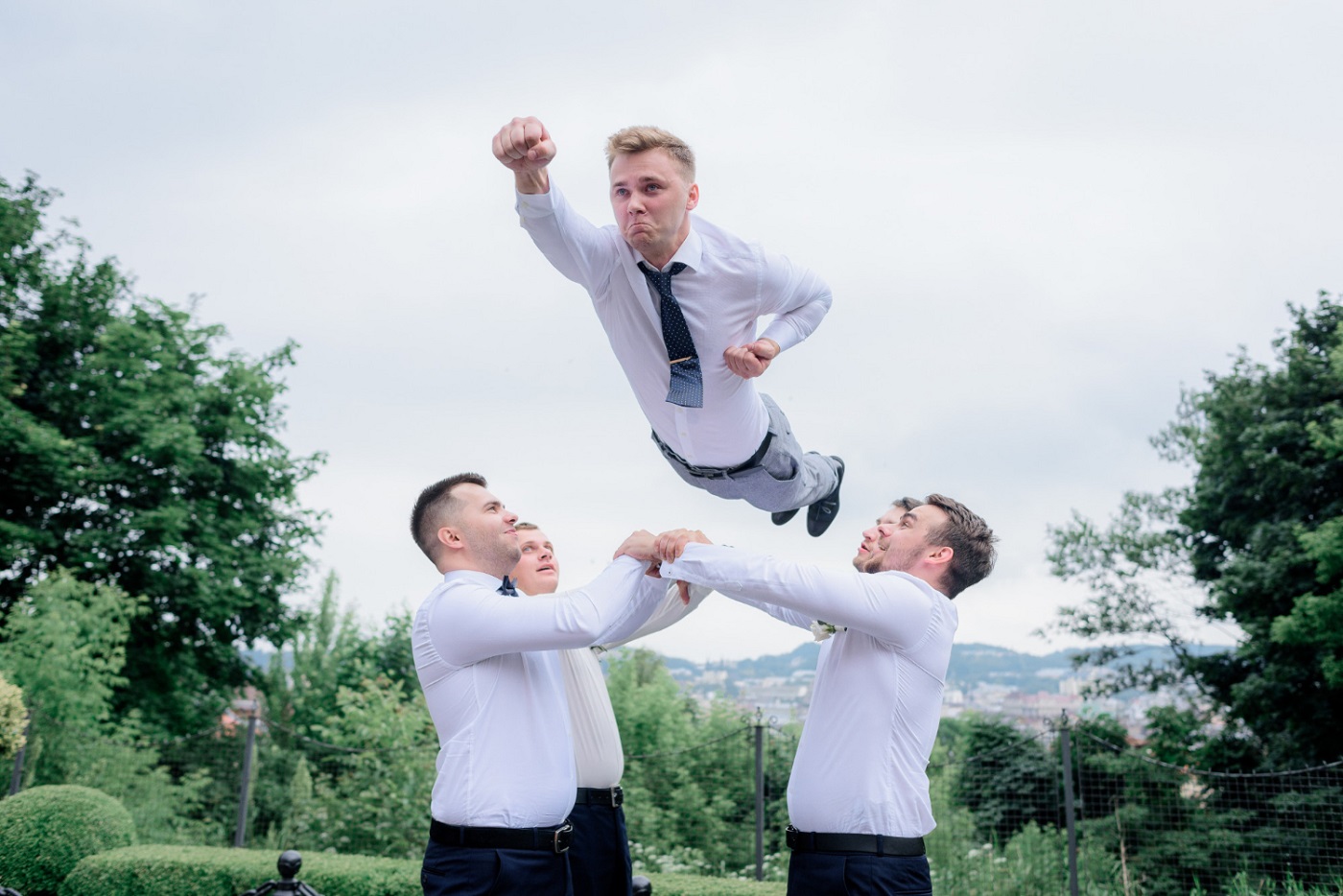 best-men-dressed-formal-attires-are-throwing-groom-like-superman-outdoors-teamwork_freepic_diller_frrepik.jpg