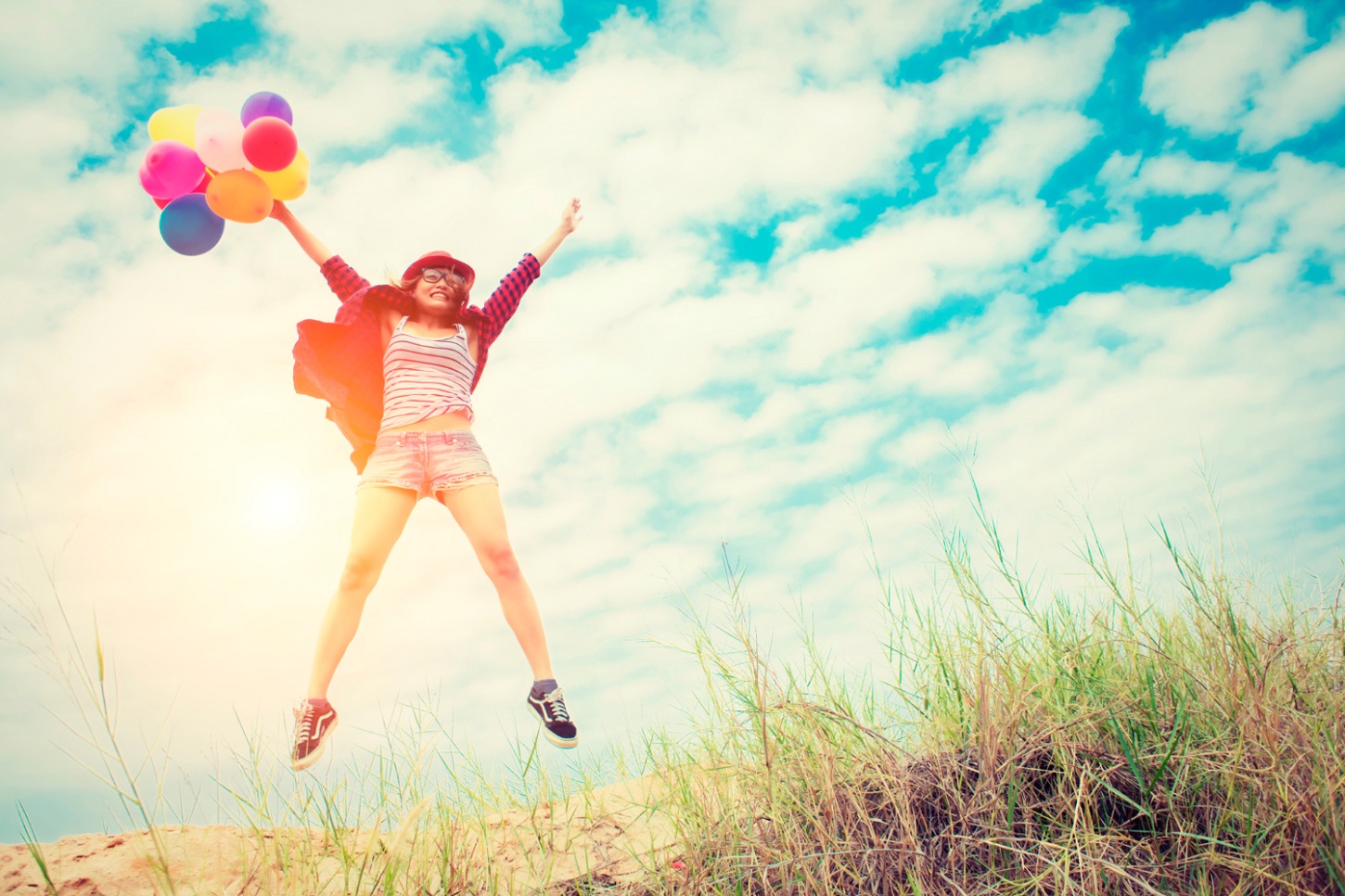 girl-jumping-beach-with-colored-balloons_jcomp_freepik.jpg