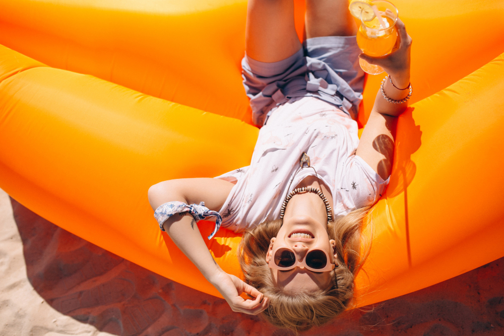 woman-with-coctail-lying-pool-mattress-beach_senivpetro_freepik.jpg