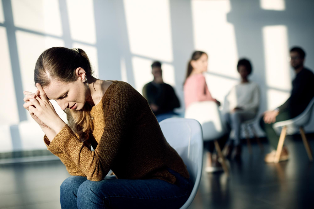 young-sad-woman-sitting-apart-from-attenders-group-therapy-community-center_drazen_zigic_freepik.jpg