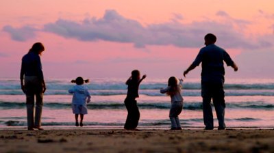stock-footage-three-children-and-two-adults-jump-on-the-beach-at-sunset.jpg