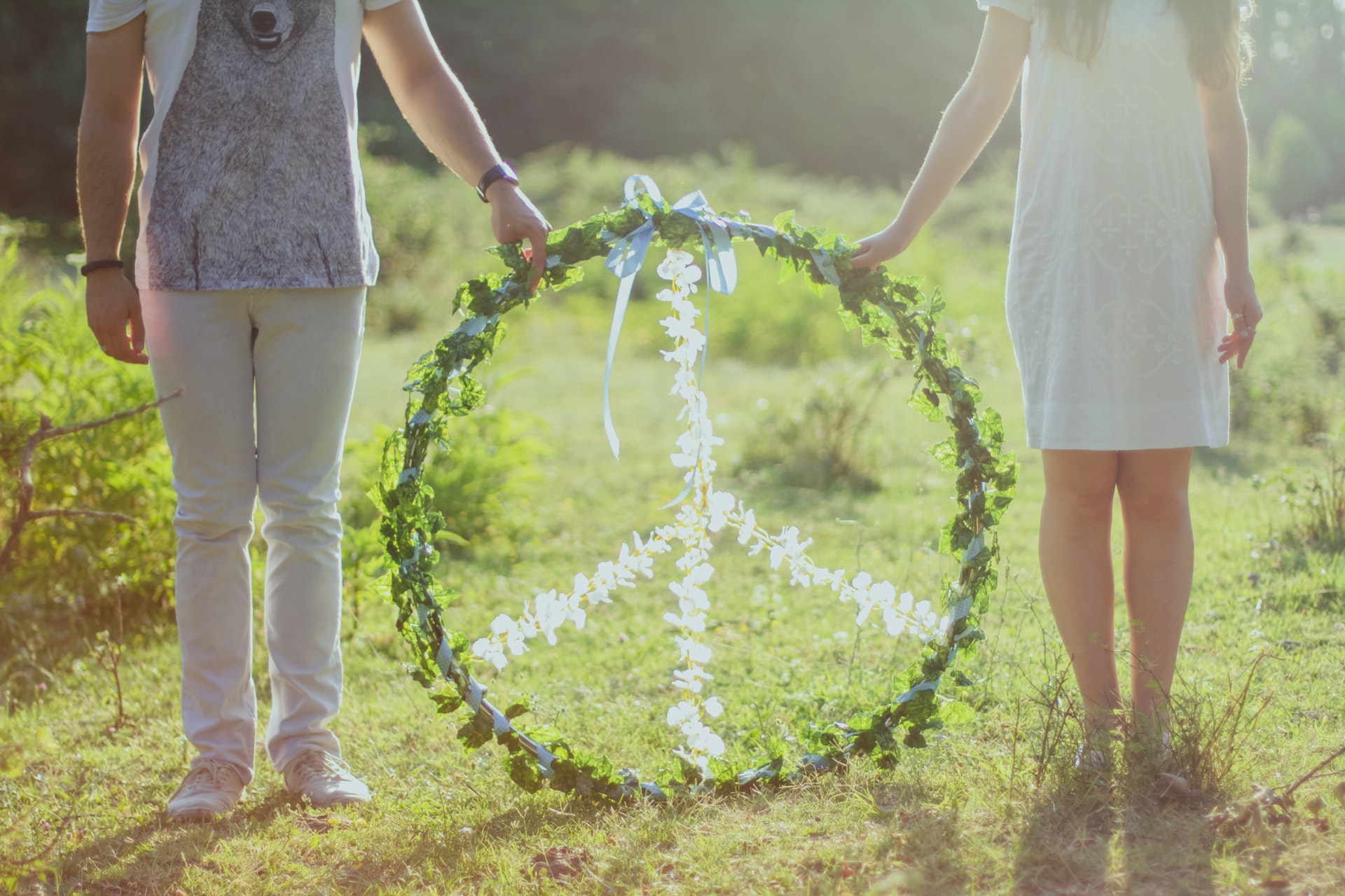 two-person-holding-white-and-green-peace-wreath-886616.jpg