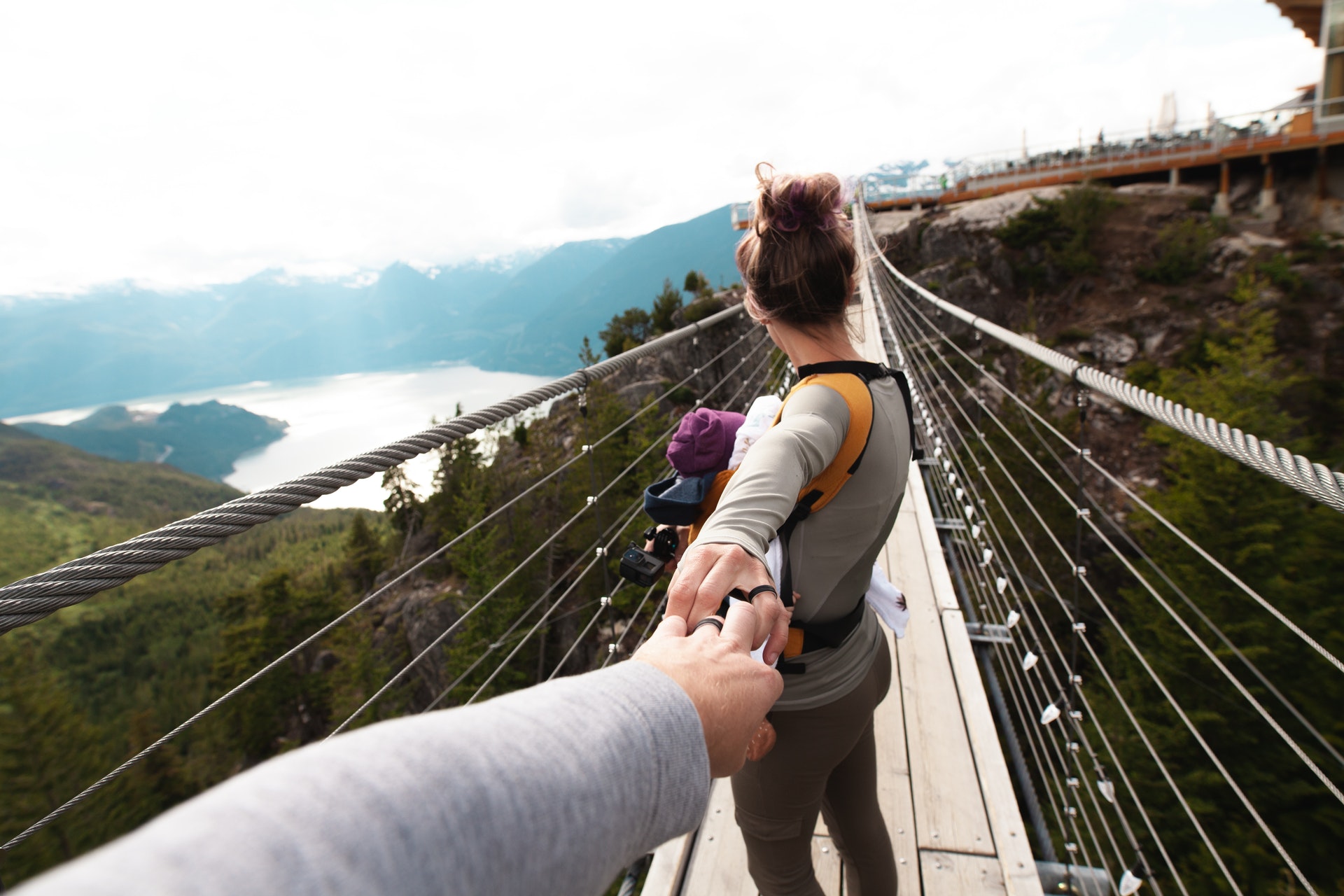 woman-with-yellow-backpack-standing-on-hanging-bridge-with-1157393.jpg