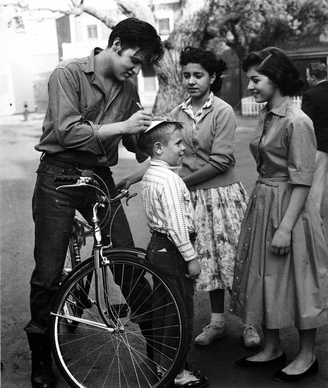 Elvis Presley signs autographs for fans in Germany, ca. 1959.jpg