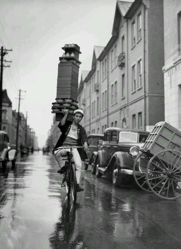 A delivery boy for a Tokyo Restaurant carries a tray of Soba Bowls.jpg