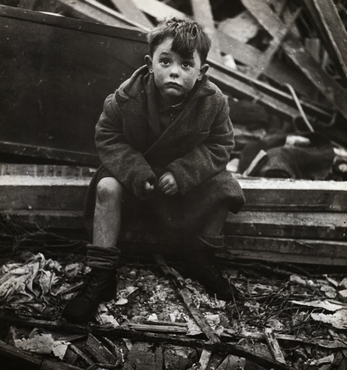 abandoned_boy_holding_a_stuffed_toy_animal_amid_ruins_following_german_aerial_bombing_of_london_1940.jpg